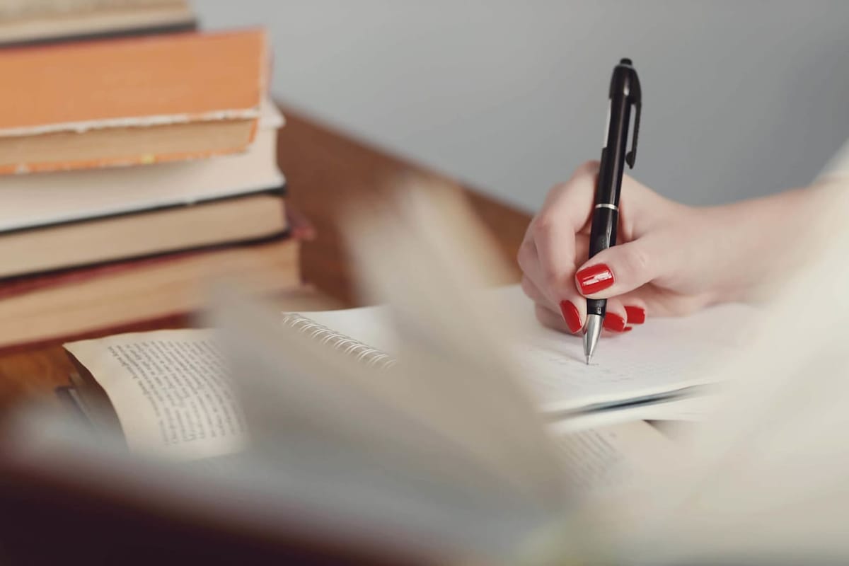 Teacher marking written essays at a desk